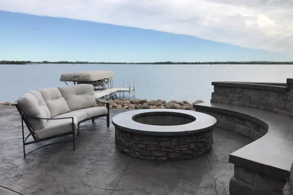 A cozy patio featuring a fire pit surrounded by comfortable seating for relaxation and social gatherings.